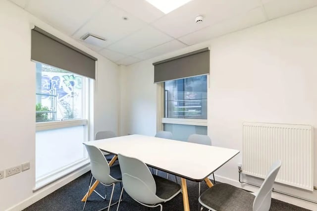 White table six chairs windows radiators study area at Hollingbury House in Brighton Student Accommodation