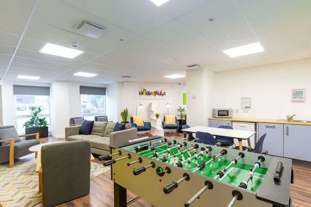 Foosball table sofas chairs kitchen common area at Hollingbury House in Brighton Student Accommodation