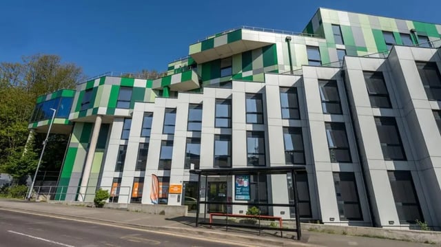 Modern building with green and white exterior exterior at Hollingbury House in Brighton Student Accommodation