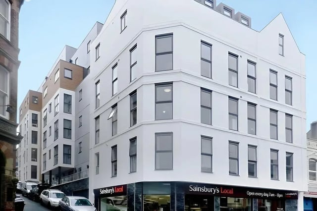 Modern building with many windows and Sainsbury's Local exterior at Frobisher House in Plymouth Student Accommodation