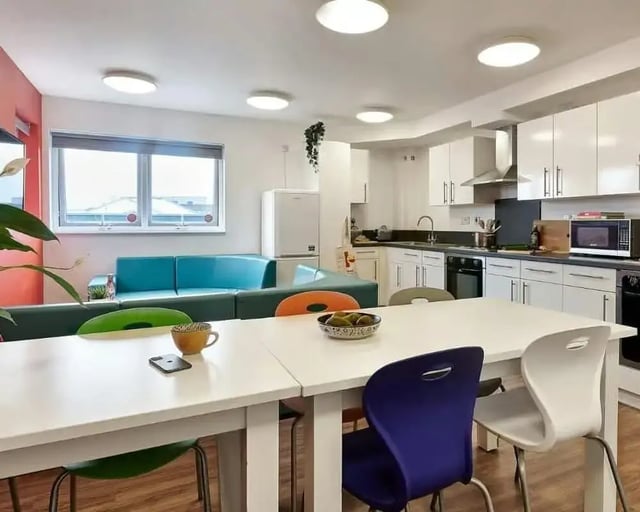 Modern kitchen living area with sofas and table at Frobisher House in Plymouth Student Accommodation