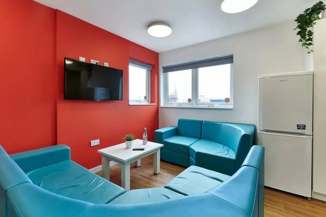 Blue sectional sofa white table TV living room at Frobisher House in Plymouth Student Accommodation