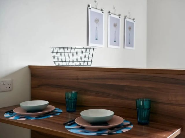 Plates bowls glasses wire basket kitchen area at Central Studios Reading in Reading Student Accommodation
