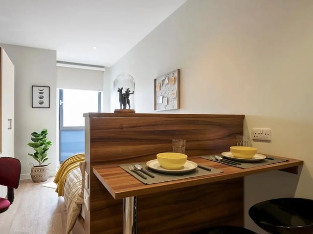 Dining set with yellow bowls and bed bedroom at Central Studios Reading in Reading Student Accommodation