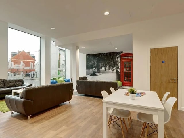 Leather couches table chairs and London mural common area at Central Studios Reading in Reading Student Accommodation