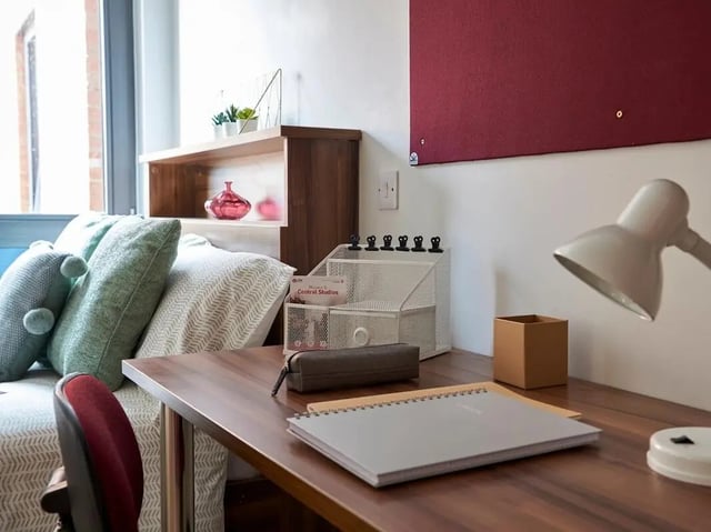 Desk with lamp notebooks and pillows bedroom at Central Studios Reading in Reading Student Accommodation