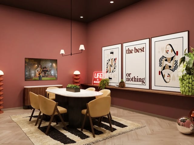 Dining table with chairs and artwork lounge area at Biscuit Factory in Belfast Student Accommodation