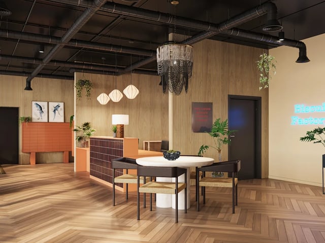 Dining table with chairs and reception desk living area at Biscuit Factory in Belfast Student Accommodation