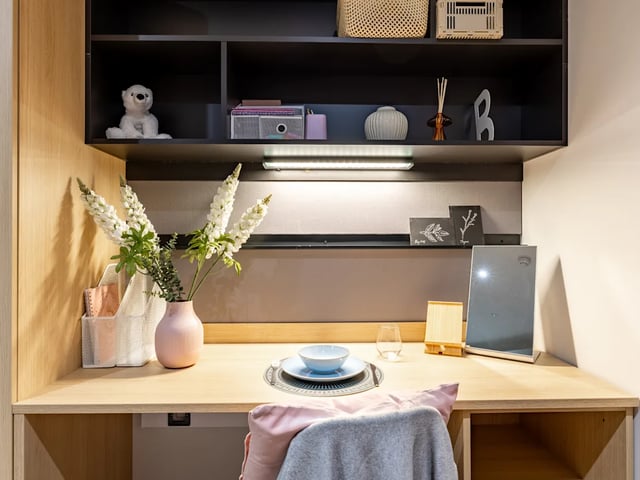 Desk with flowers and study items study area at Biscuit Factory in Belfast Student Accommodation