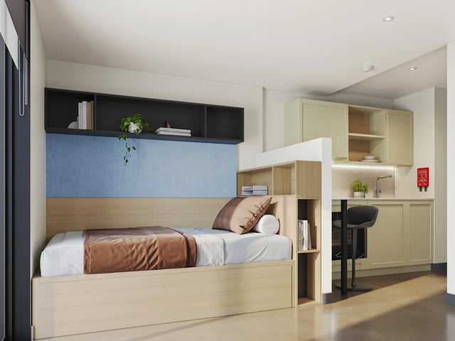 Bed bookshelf kitchen counter and bar stool studio at Biscuit Factory in Belfast Student Accommodation
