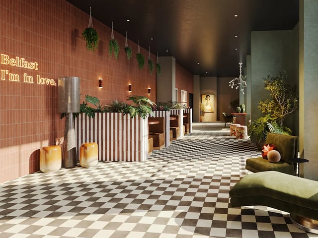 Reception desk plants neon sign checkered floor lounge exterior at Biscuit Factory in Belfast Student Accommodation
