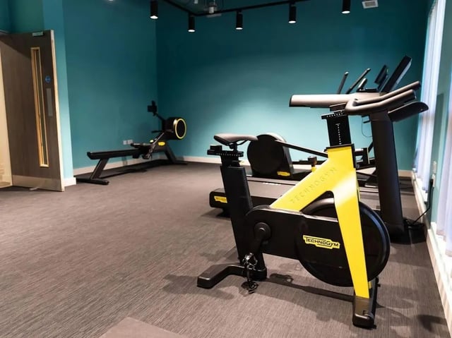 Gym equipment includes spin bike and rower playing area at Stanley Studios - Portsmouth in Portsmouth Student Accommodation