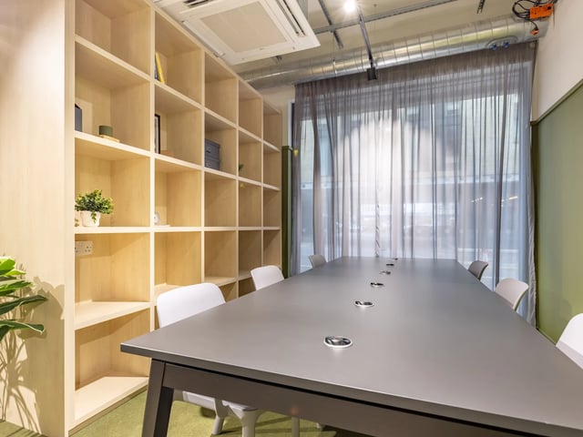 Large meeting table with chairs bookshelf and curtains Meeting room at Stanley Studios - Dundee in Dundee Student Accommodation