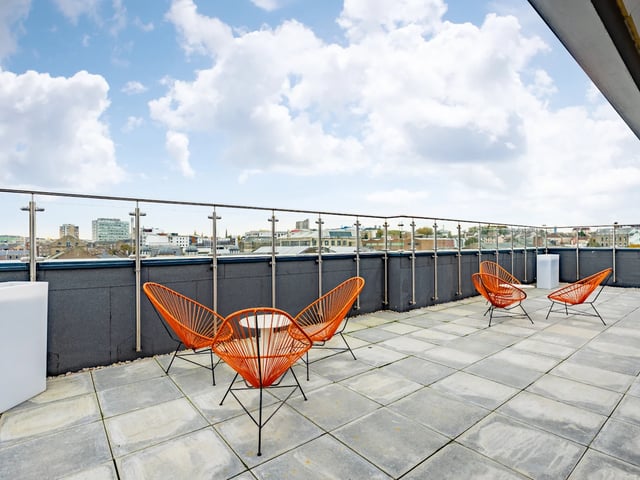 Orange chairs and table on patio exterior at Stanley Studios - Dundee in Dundee Student Accommodation