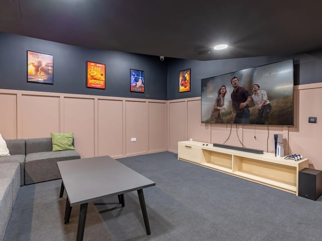 Sofa coffee table TV and movie posters Living room at Stanley Studios - Dundee in Dundee Student Accommodation
