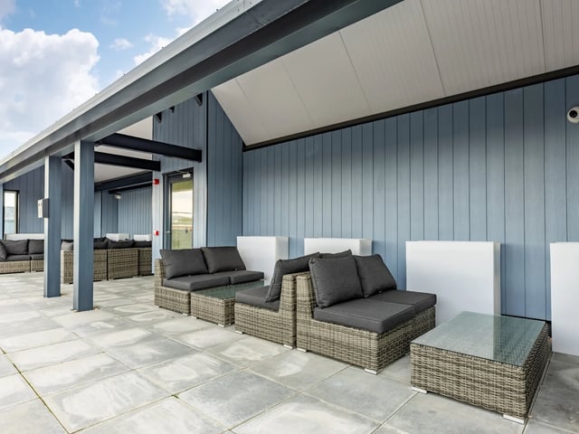 Wicker lounge furniture with glass tables exterior at Stanley Studios - Dundee in Dundee Student Accommodation