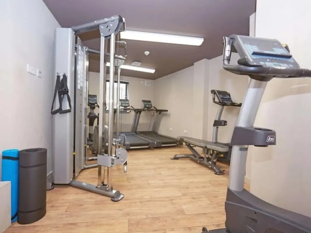 Gym equipment treadmills weight machine bench fitness room at Woodside House in Glasgow Student Accommodation