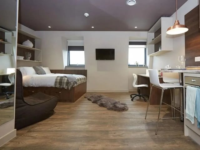 Bed study desk TV and kitchen area studio at Woodside House in Glasgow Student Accommodation