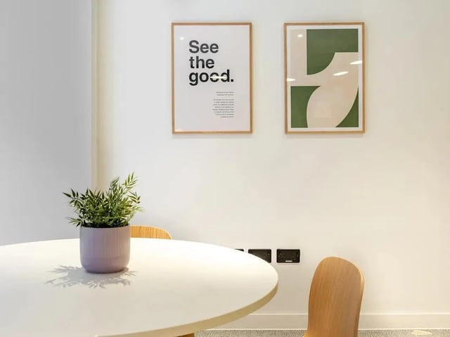 Round white table with potted plant and chairs living room at Glassworks in Bristol Student Accommodation