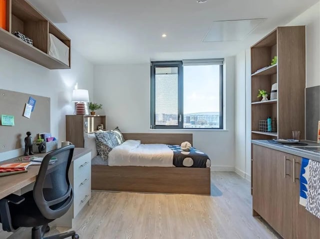 Bed desk chair shelves kitchen and window bedroom at Glassworks in Bristol Student Accommodation