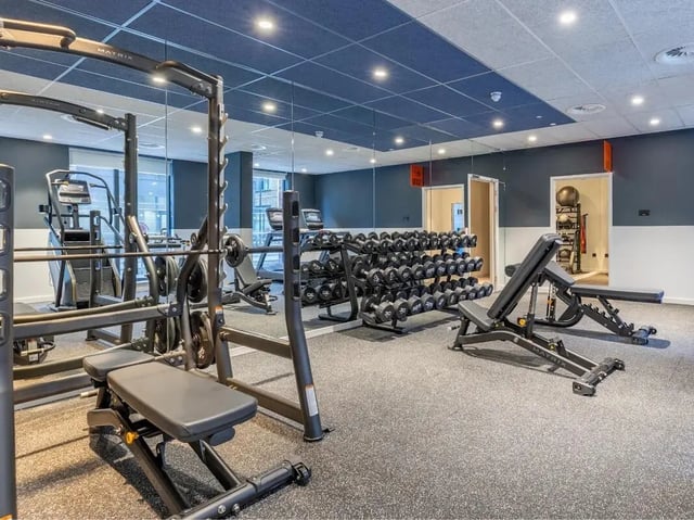 Dumbbell rack weight benches treadmills gym area at Glassworks in Bristol Student Accommodation