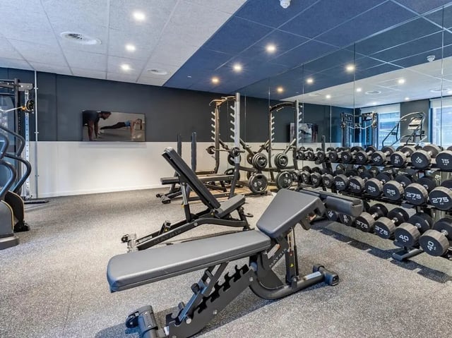 Dumbbells weight benches cardio machines gym at Glassworks in Bristol Student Accommodation