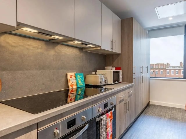 Modern kitchen with oven microwave and cabinets kitchen at Glassworks in Bristol Student Accommodation