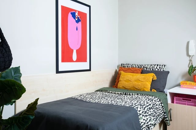 Bed with art print and pillows bedroom at Purbeck House in Bournemouth Student Accommodation