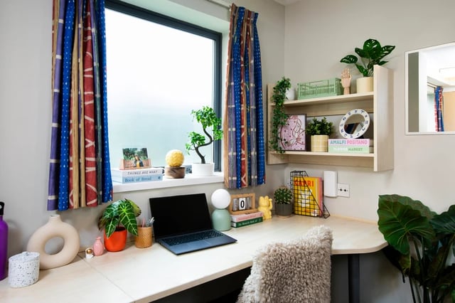 Desk with laptop plants and bookshelf study area at Purbeck House in Bournemouth Student Accommodation