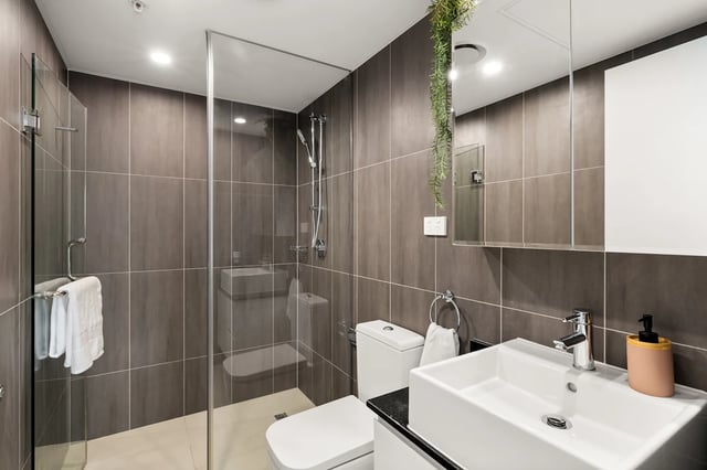 Modern bathroom with shower toilet sink and mirror Bathroom at UKO Parramatta Central in Sydney Student Accommodation