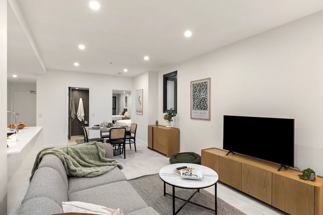 Sofa dining table TV and kitchen living area at UKO Parramatta Central in Sydney Student Accommodation