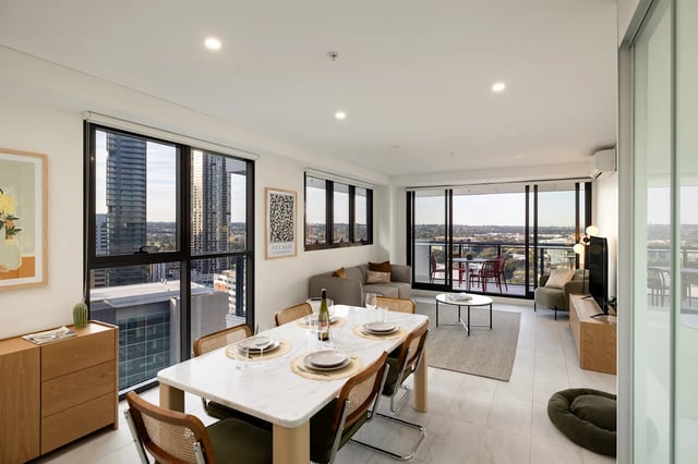 Dining table sofa balcony chairs living room exterior at UKO Parramatta Central in Sydney Student Accommodation