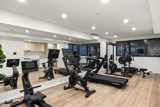 Gym equipment includes treadmills bikes and weights gym area at UKO Parramatta Central in Sydney Student Accommodation