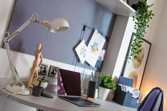 Desk lamp laptop mannequin art study area at 123 York Street in Belfast Student Accommodation