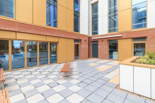 Paved courtyard with bench and planter exterior at 123 York Street in Belfast Student Accommodation