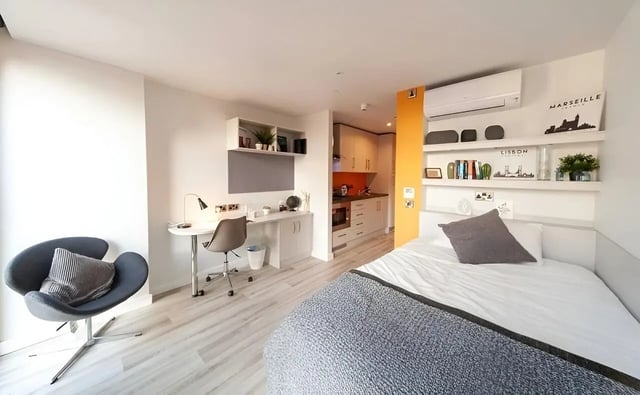 Bed desk and kitchen studio apartment at 123 York Street in Belfast Student Accommodation