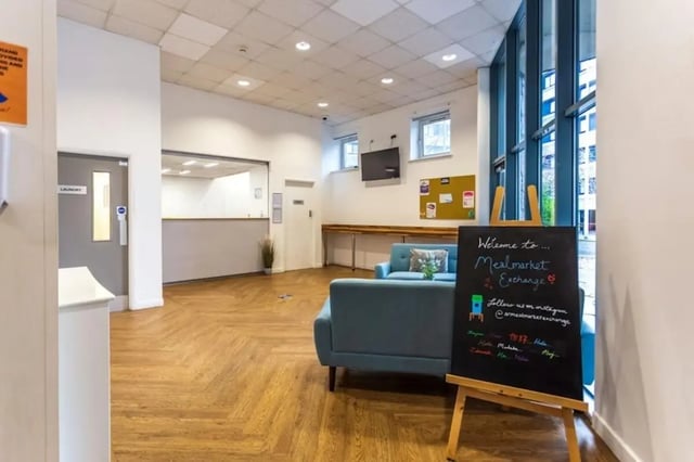 Reception area with blue sofas and chalkboard Living Room at Mealmarket Exchange in Aberdeen Student Accommodation