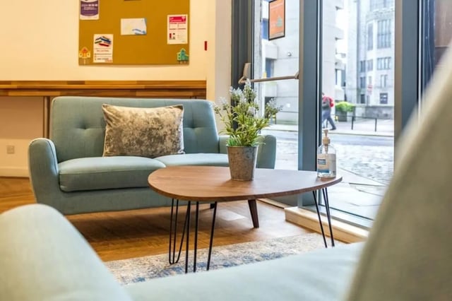 Blue sofa with pillow and plant living room at Mealmarket Exchange in Aberdeen Student Accommodation