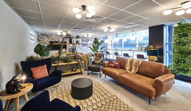 Sofas chairs coffee table and shelves living room at Capital Gate in Liverpool Student Accommodation