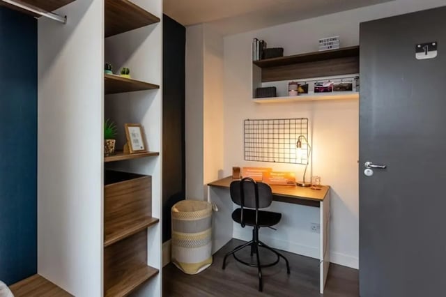Desk with chair shelves and laundry basket bedroom at Regents Court in Leicester Student Accommodation