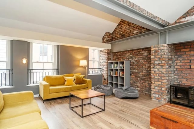 Yellow couches coffee table bookshelf beanbags living room at Sheffield 3 in Sheffield Student Accommodation