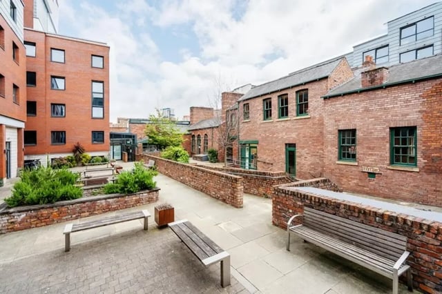Courtyard with brick buildings benches and greenery exterior at Sheffield 3 in Sheffield Student Accommodation