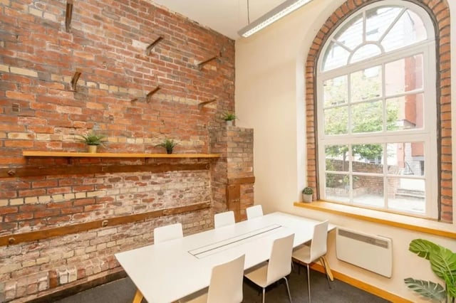 White table with chairs brick wall arched window meeting room at Sheffield 3 in Sheffield Student Accommodation