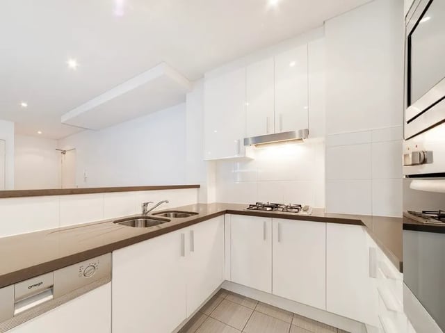 White cabinets sink dishwasher stovetop oven kitchen at Belong Waterloo in Sydney Student Accommodation