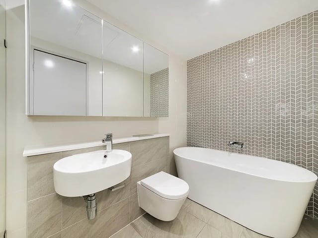 Modern bathroom with bathtub toilet and vanity bathroom at Belong Waterloo in Sydney Student Accommodation