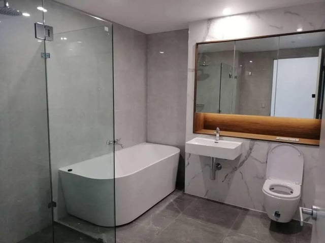 Modern bathtub sink toilet mirror bathroom at Belong Macquarie in Sydney Student Accommodation