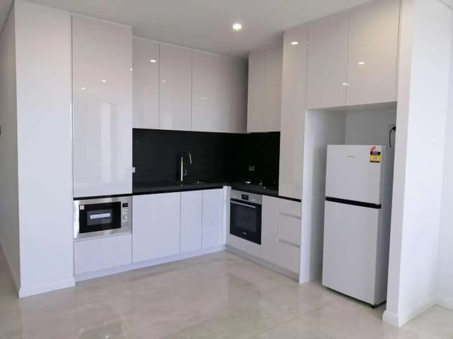 White cabinets microwave oven oven fridge kitchen at Belong Macquarie in Sydney Student Accommodation
