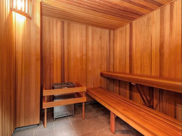 Wooden sauna benches with heater Interior Sauna at Belong Zetland in Sydney Student Accommodation