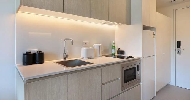 Modern student kitchenette with sink toaster microwave and fridge kitchen at Iglu Waterloo in Sydney Student Accommodation