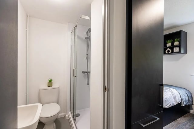 Sink toilet shower and bed Bathroom and bedroom at Woodhouse Flats in Leeds Student Accommodation
